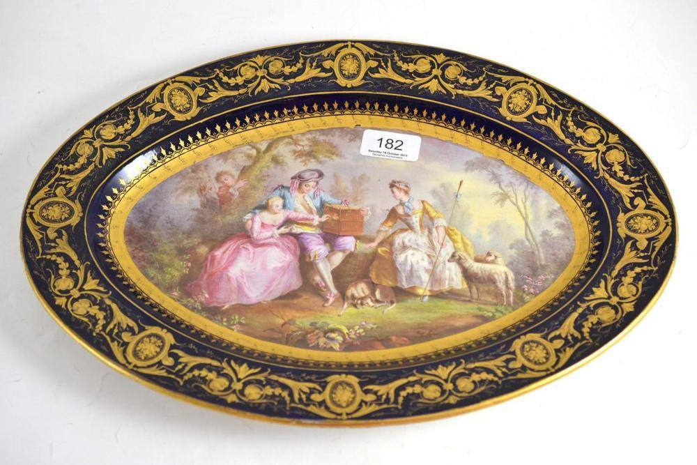 Lot 182 - An oval Sevres style dish decorated with a garden setting