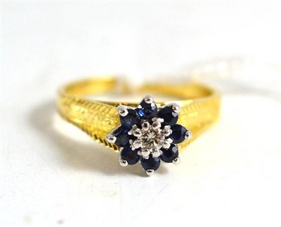 Lot 258 - An 18ct gold diamond and sapphire ring