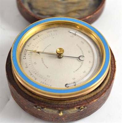 Lot 264 - An cased brass and enamel pocket aneroid barometer