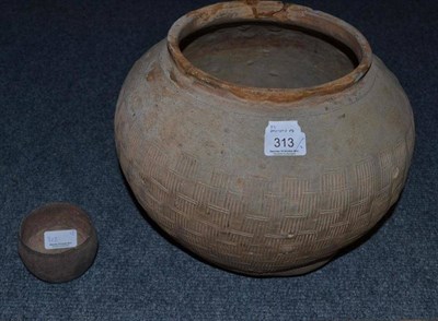 Lot 313 - A Chinese terracotta jar, possibly Warring States with combed decoration, 28cm; and a similar...