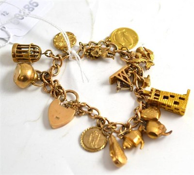 Lot 366 - A charm bracelet hung with fourteen charms