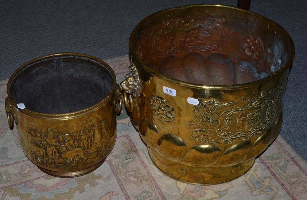 Lot 519 - A large brass planter with lion mask handles and a smaller example