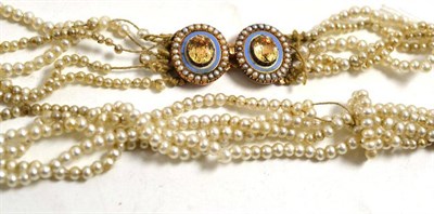Lot 15 - A simulated pearl necklace with a double clasp of yellow topaz, blue enamel and seed pearls, length