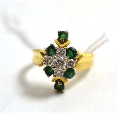 Lot 26 - An 18ct gold emerald and diamond cluster ring, total estimated diamond weight 0.40 carat...