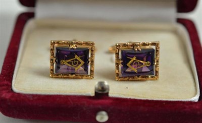 Lot 53 - A pair of Masonic cufflinks, stamped '14K' and '585', each set with an inlaid purple stone and with