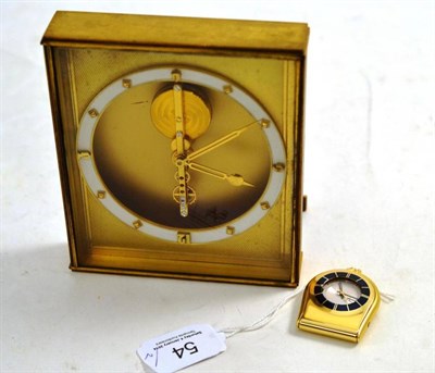 Lot 54 - An alarm travelling watch, signed Jaeger LeCoultre, Memovox, circa 1965, 36mm wide, and a gilt...