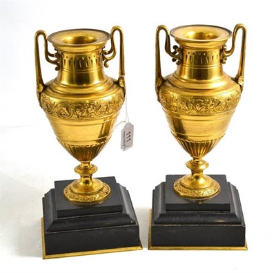 Lot 111 - A pair of late 19th century gilt brass and black marble vases, 29cm high