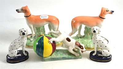 Lot 150 - A pair of Staffordshire pottery greyhounds, a similar pair of seated dalmatians and a pottery...