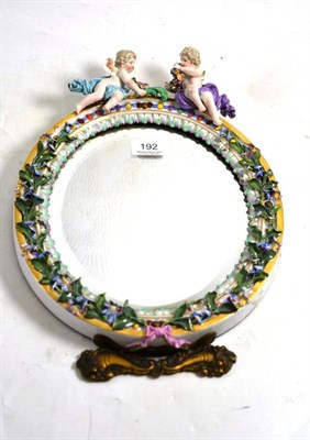 Lot 192 - A late 19th century Meissen cherub and encrusted mirror, 36cm high