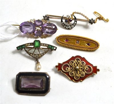 Lot 236 - A diamond and ruby set brooch stamped '15CT', an amethyst brooch, a red enamelled brooch - possibly