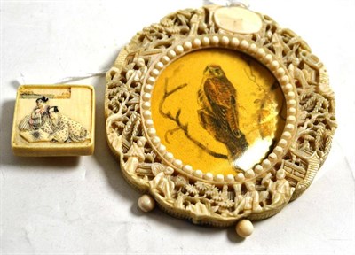 Lot 237 - Late 19th century carved ivory photo frame and a square ivory stud (2)