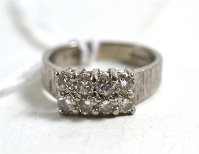 Lot 242 - An 18ct white gold diamond two row ring, eight round brilliant cut diamonds in claw settings to...