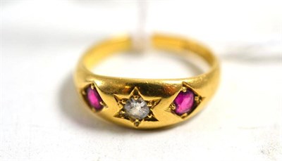 Lot 243 - An 18ct gold ruby and diamond three stone ring, finger size J