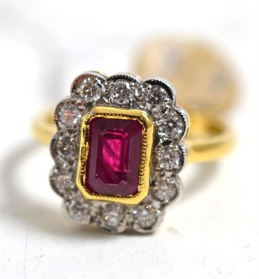 Lot 247 - An 18ct gold ruby and diamond cluster ring, a step cut ruby within a border of round brilliant...