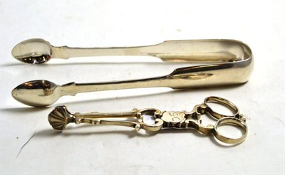 Lot 260 - A pair of Georgian silver scissor sugar nips and a pair of Victorian sugar nips, Exeter marks