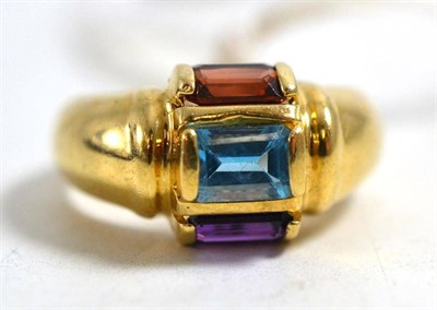 Lot 270 - A 14ct gold multi gemstone ring, set with a baguette cut amethyst, blue topaz and a garnet, in...