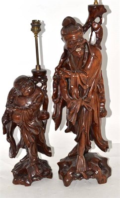 Lot 278 - Oriental carved rootwood figure of a man holding fish converted to a table lamp, 56cm and a smaller