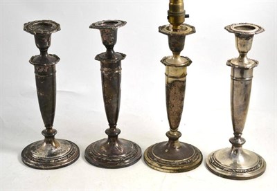 Lot 281 - Set of four American filled sterling candlesticks by Kirk & Sons, complete with nozzles