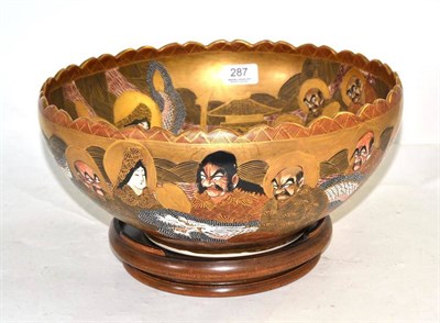 Lot 287 - A Japanese Satsuma bowl and wood stand, 32cm diameter