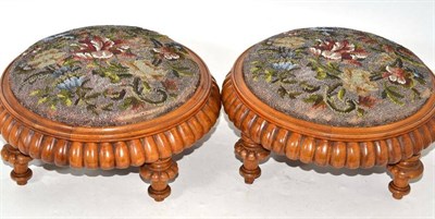 Lot 294 - A pair of Victorian walnut and beadwork footstools