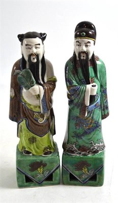 Lot 316 - A pair of Chinese porcelain figures of immortals, early 20th century, in imitation of Kangxi...