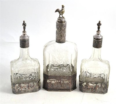 Lot 325 - Silver plated and engraved decanter with a pair of engraved decanters