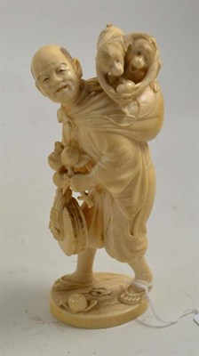 Lot 349 - A Japanese ivory figure with two monkeys, Meiji period, circa 1900, 19cm high