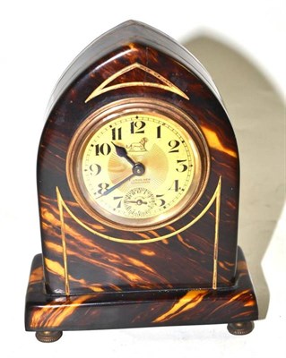 Lot 359 - A faux tortoiseshell desk alarm timepiece, circa 1920, 14cm high