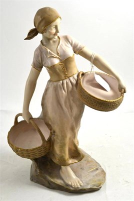 Lot 382 - An Austrian figure modelled as a lady with two baskets, 38cm high