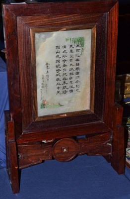 Lot 400 - A Chinese rosewood table screen, 20th century, set with low relief carved soapstone panel depicting