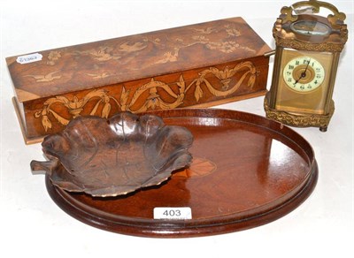 Lot 403 - A brass carriage clock, small oval mahogany tray, poker work glove box and a carved tray in form of