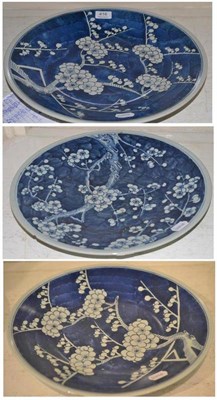 Lot 416 - Three late 19th century Chinese blue and white prunus blossom dishes, two 37cm and one 39cm...