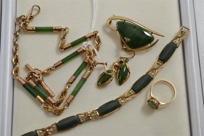 Lot 480 - A group of jade type and green hardstone set jewellery including an Albert, a brooch, a ring, a...