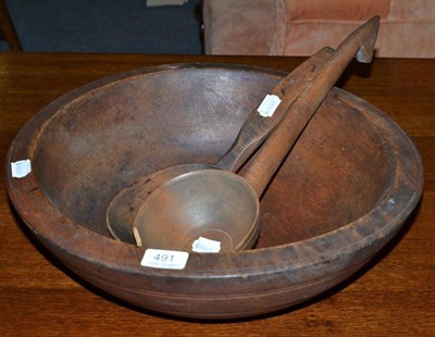 Lot 491 - A sycamore dairy bowl and two ladles