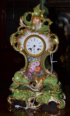 Lot 501 - A French Rococo style porcelain clock, the case and stand, decorated with flower sprays on an apple