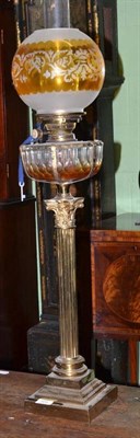 Lot 505 - A Victorian Corinthian column brass oil lamp, with blown glass shade and chimney