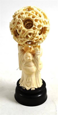 Lot 520 - An early 20th century carved ivory puzzle ball on stand, 17cm high