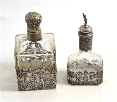 Lot 538 - A Dutch silver and engraved bottle with a smaller example