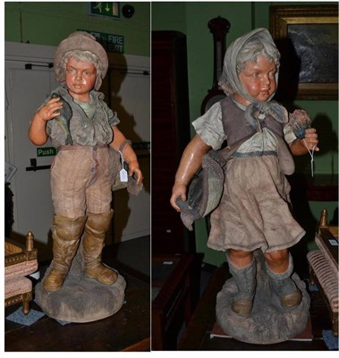 Lot 546 - A pair of Continental polychrome pottery life size figures of children, circa 1900, as a little boy