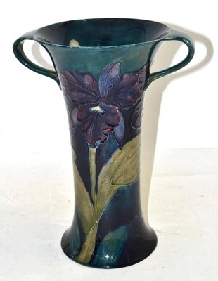 Lot 557 - A William Moorcroft Orchid pattern twin-handled vase, circa 1919, with purple and mauve orchids...