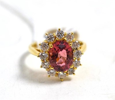 Lot 582 - An 18ct gold pink tourmaline and diamond cluster ring, the oval mixed cut pink tourmaline...