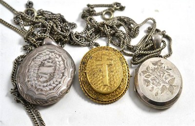 Lot 583 - Victorian silver locket on chain, another on chain and a pinchbeck locket back brooch