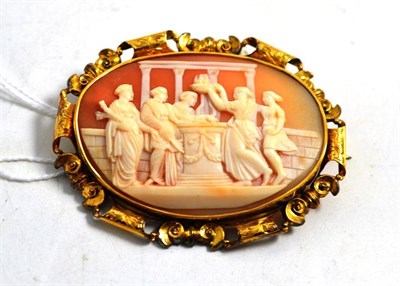 Lot 588 - A cameo brooch, carved with a classical scene, in an engraved frame, illegible signature to the...