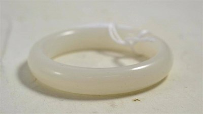 Lot 592 - A Chinese white jade type bangle, 8cm diameter