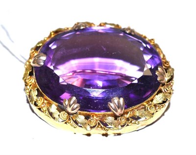 Lot 599 - A large amethyst brooch in a foliate decorated frame, measures 4.4cm by 3.7cm