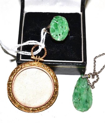 Lot 603 - A carved jade pendant on chain, a similar ring, finger size R, and a picture locket, stamped...