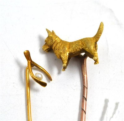 Lot 656 - A cultured pearl set wishbone stick pin, and a dog motif stick pin (2)