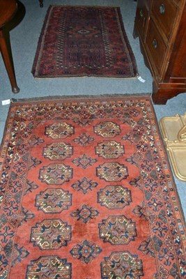 Lot 690 - Afghan rug, North Afghanistan, the madder field with two columns of quartered guls enclosed by...