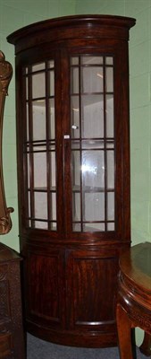 Lot 694 - William IV mahogany bow front standing corner cabinet, with key