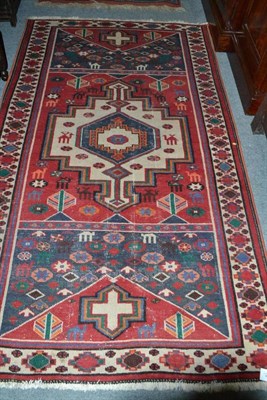 Lot 698 - Pakistan Bukhara rug, Punjab, the rust compartmentalised field enclosed by borders of hooked...